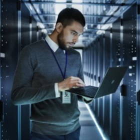 Office employee using laptop technology in a database room super computer